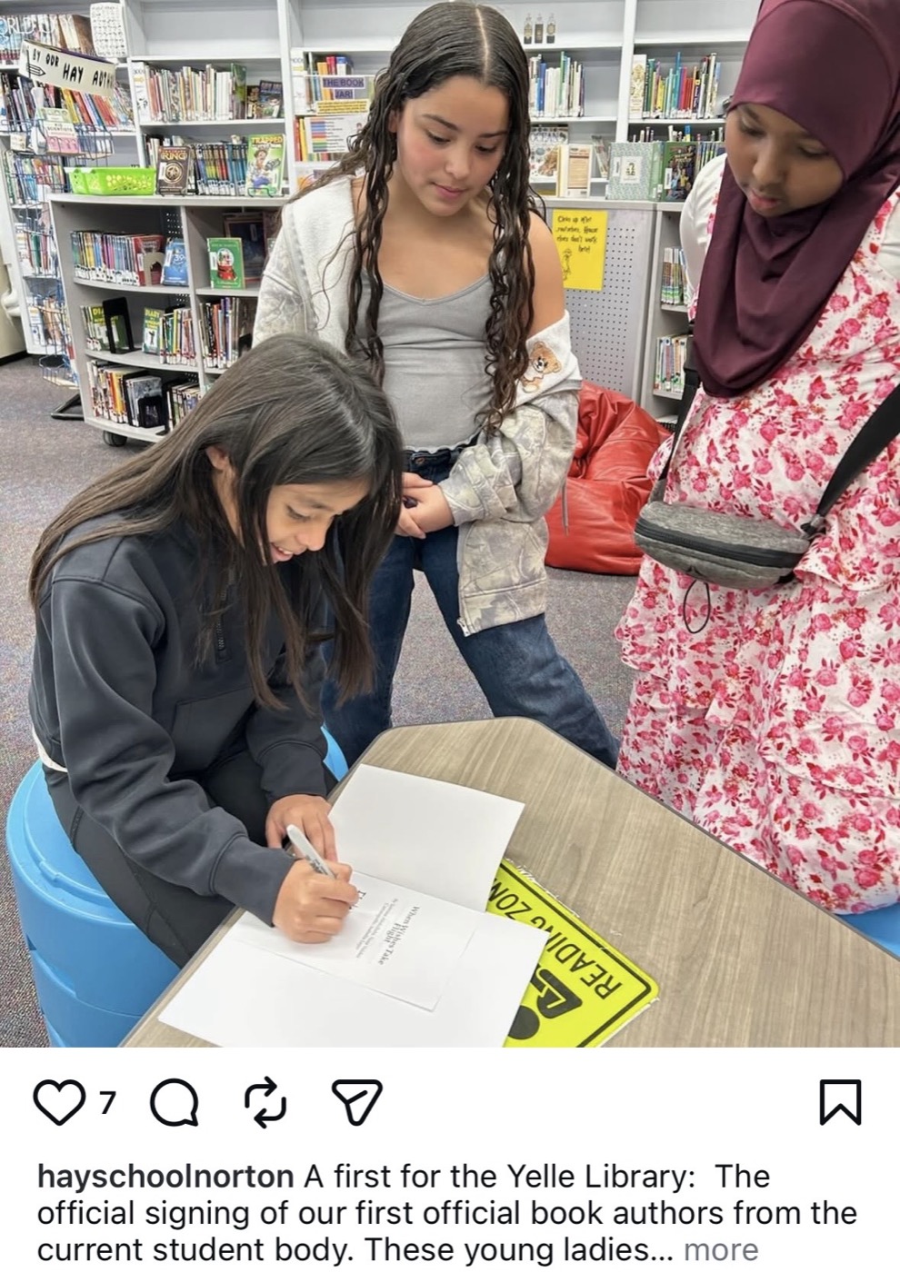 Students signing printed books