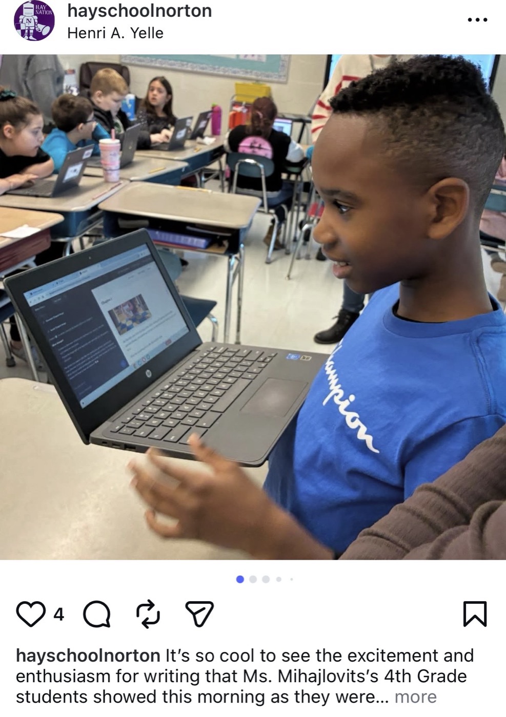 Excited student sharing an ImagineAI story on a classroom laptop
